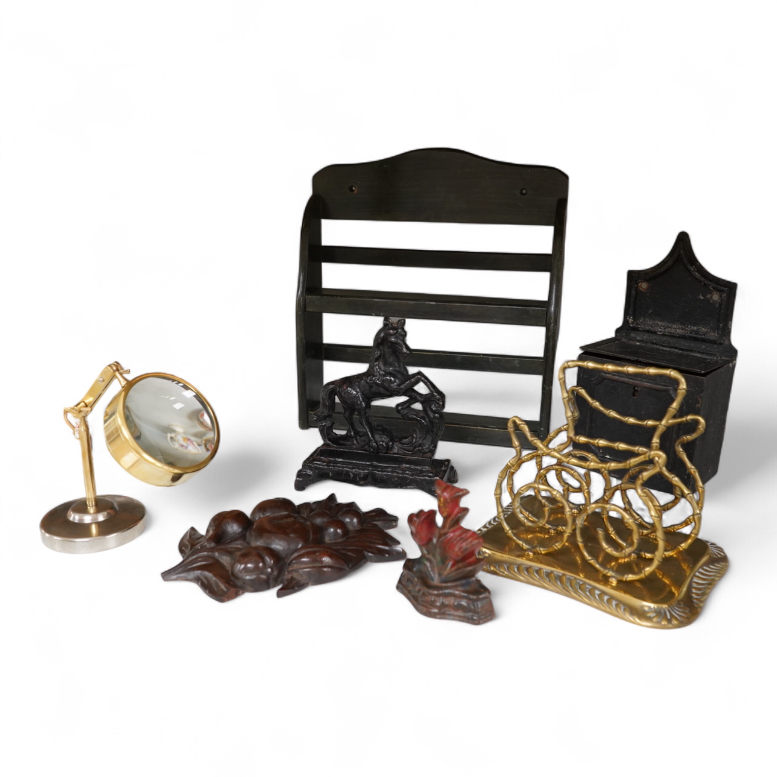 Sundry items to include an iron money box, brass letter rack, horse door stop and a 19th century oak carving, largest 32cm high